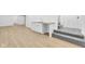 Basement with wood-look vinyl plank flooring, a kitchenette, carpeted stairs and white trim at 2031 Central Ave, Indianapolis, IN 46202