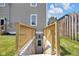 Basement entrance with wood railing and steps leading to the backyard at 2031 Central Ave, Indianapolis, IN 46202