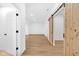 Finished basement area featuring wood grain flooring, white walls and natural wood doors at 2031 Central Ave, Indianapolis, IN 46202