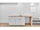 Basement kitchenette featuring white cabinets, wood countertop, stainless steel sink and carpeted stairs at 2031 Central Ave, Indianapolis, IN 46202