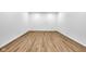 Spacious basement with wood grain flooring and white walls, ready for customization at 2031 Central Ave, Indianapolis, IN 46202