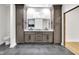 Bathroom featuring dual vanities with granite counters, dark cabinets, tile floors, and modern lighting at 2031 Central Ave, Indianapolis, IN 46202
