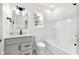 A well-lit bathroom features a gray vanity, white fixtures, and a shower-tub combo at 2031 Central Ave, Indianapolis, IN 46202