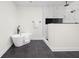 Elegant bathroom showcasing a modern tub, separate shower, and dark gray tile flooring at 2031 Central Ave, Indianapolis, IN 46202