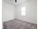 Simple bedroom with neutral carpet and a bright window at 2031 Central Ave, Indianapolis, IN 46202