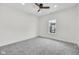 A bright, minimalist bedroom has gray carpet and a large window at 2031 Central Ave, Indianapolis, IN 46202