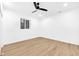Bedroom features wood-look vinyl plank flooring, a window, neutral walls and a black ceiling fan at 2031 Central Ave, Indianapolis, IN 46202