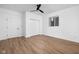 Bright bedroom featuring hard surface floors, ample closet space, and a ceiling fan at 2031 Central Ave, Indianapolis, IN 46202