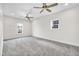 This bedroom is spacious with neutral walls, gray carpet, updated ceiling fans and natural light at 2031 Central Ave, Indianapolis, IN 46202