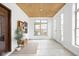 Welcoming entryway with natural light, a wooden bench, and stylish decor at 2031 Central Ave, Indianapolis, IN 46202