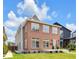 Charming two-story home with brick and siding, complemented by a lush green lawn at 2031 Central Ave, Indianapolis, IN 46202