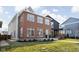 Modern two-story home featuring brick facade, large windows, and well-manicured lawn at 2031 Central Ave, Indianapolis, IN 46202