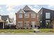 Charming two-story brick home featuring symmetrical windows and a well-maintained front yard at 2031 Central Ave, Indianapolis, IN 46202
