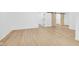 Hallway with wood-look vinyl plank flooring, a sliding barn door and open doorway to another room at 2031 Central Ave, Indianapolis, IN 46202