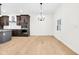 Well-lit kitchen with stainless steel appliances, grey cabinetry, and hardwood floors at 2031 Central Ave, Indianapolis, IN 46202