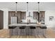 Modern kitchen featuring a marble island with seating, dark cabinetry, and stylish pendant lighting at 2031 Central Ave, Indianapolis, IN 46202