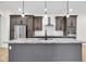 The kitchen showcases a gray island with marble countertop, a stainless range hood, and modern pendant lighting at 2031 Central Ave, Indianapolis, IN 46202