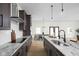 Gourmet kitchen featuring marble counters, stainless appliances, and an open layout to the dining area at 2031 Central Ave, Indianapolis, IN 46202