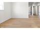 Spacious living room with hardwood floors, bright white walls, a large window and a doorway at 2031 Central Ave, Indianapolis, IN 46202