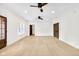 Bright living room with hardwood floors, ceiling fan, interior doors, and bright white walls at 2031 Central Ave, Indianapolis, IN 46202