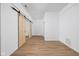 Open concept area featuring hard surface floors and a barn door leading to another room at 2031 Central Ave, Indianapolis, IN 46202
