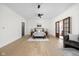 Bright main bedroom features hardwood floors, ceiling fan, and doors leading to a private outdoor area at 2031 Central Ave, Indianapolis, IN 46202