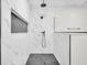 Luxurious shower with stone accents, black hardware, and rainfall shower head at 2031 Central Ave, Indianapolis, IN 46202