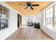 Relaxing sunroom filled with light, a ceiling fan, wood ceiling, two chairs and a small table at 2031 Central Ave, Indianapolis, IN 46202