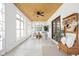 Bright sunroom with large windows, comfortable seating, and a decorative ceiling fan at 2031 Central Ave, Indianapolis, IN 46202
