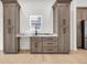 A stylish wet bar features gray cabinets, marble countertops, and convenient storage at 2031 Central Ave, Indianapolis, IN 46202