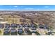 Broad aerial view of a residential community highlighting diverse home styles, tree-lined streets, and a distant, sprawling cityscape at 281 Dovetree Dr, Danville, IN 46122