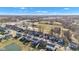 Overhead perspective of a suburban area showcasing rows of neatly arranged homes, green spaces, and community amenities under a blue sky at 281 Dovetree Dr, Danville, IN 46122