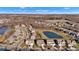 Wide aerial shot of a suburban neighborhood with manicured lawns, diverse home styles, and a peaceful pond in the background at 281 Dovetree Dr, Danville, IN 46122