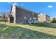 Large backyard with green grass, a dark fence, and a wooden deck, creating a private outdoor space at 281 Dovetree Dr, Danville, IN 46122