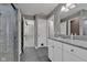 Bathroom features a white dual sink vanity, tiled floors, and a tiled shower with glass door at 281 Dovetree Dr, Danville, IN 46122