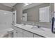 Bathroom with a dual sink vanity, white cabinets, and a shower-tub combo at 281 Dovetree Dr, Danville, IN 46122
