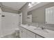 Bathroom with a dual sink vanity, white cabinets, and a shower-tub combo at 281 Dovetree Dr, Danville, IN 46122
