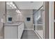 Bathroom features dual sink vanity, granite countertop, tiled shower, and dark tile floors at 281 Dovetree Dr, Danville, IN 46122