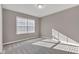 An empty bedroom features plush carpeting, neutral paint, and natural light from window blinds at 281 Dovetree Dr, Danville, IN 46122