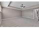 Expansive bedroom boasts neutral paint, carpet, tray ceiling, and ceiling fan at 281 Dovetree Dr, Danville, IN 46122