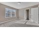 Bedroom with plush carpeting, a sunlit window, and access to a walk-in closet at 281 Dovetree Dr, Danville, IN 46122