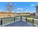 Close-up view of the deck with black and white railings overlooking a pond and a lush green backyard at 281 Dovetree Dr, Danville, IN 46122