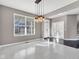 Bright dining room featuring herringbone floors, modern light fixture, and adjacent rooms at 281 Dovetree Dr, Danville, IN 46122