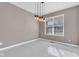 Bright dining room with herringbone floors, modern light fixture and large window with blinds at 281 Dovetree Dr, Danville, IN 46122