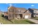 Beautiful home featuring a brick and siding exterior, a well-manicured lawn, and an attached garage at 281 Dovetree Dr, Danville, IN 46122