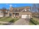 Beautiful two-story home with a brick and siding facade, a well-manicured lawn, and a spacious driveway at 281 Dovetree Dr, Danville, IN 46122