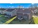 Rear exterior view of the home, showing the backyard with a deck, fire pit, black metal fence, and well-maintained lawn at 281 Dovetree Dr, Danville, IN 46122