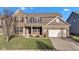 Two-story home featuring a brick and siding exterior, attached garage, and a well-maintained front yard at 281 Dovetree Dr, Danville, IN 46122