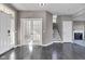 Open foyer with dark wood floors, white trim, a staircase, and a view into a living room with a fireplace at 281 Dovetree Dr, Danville, IN 46122