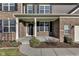 Inviting front porch featuring classic brickwork, white columns, and a charming front door with a wreath at 281 Dovetree Dr, Danville, IN 46122